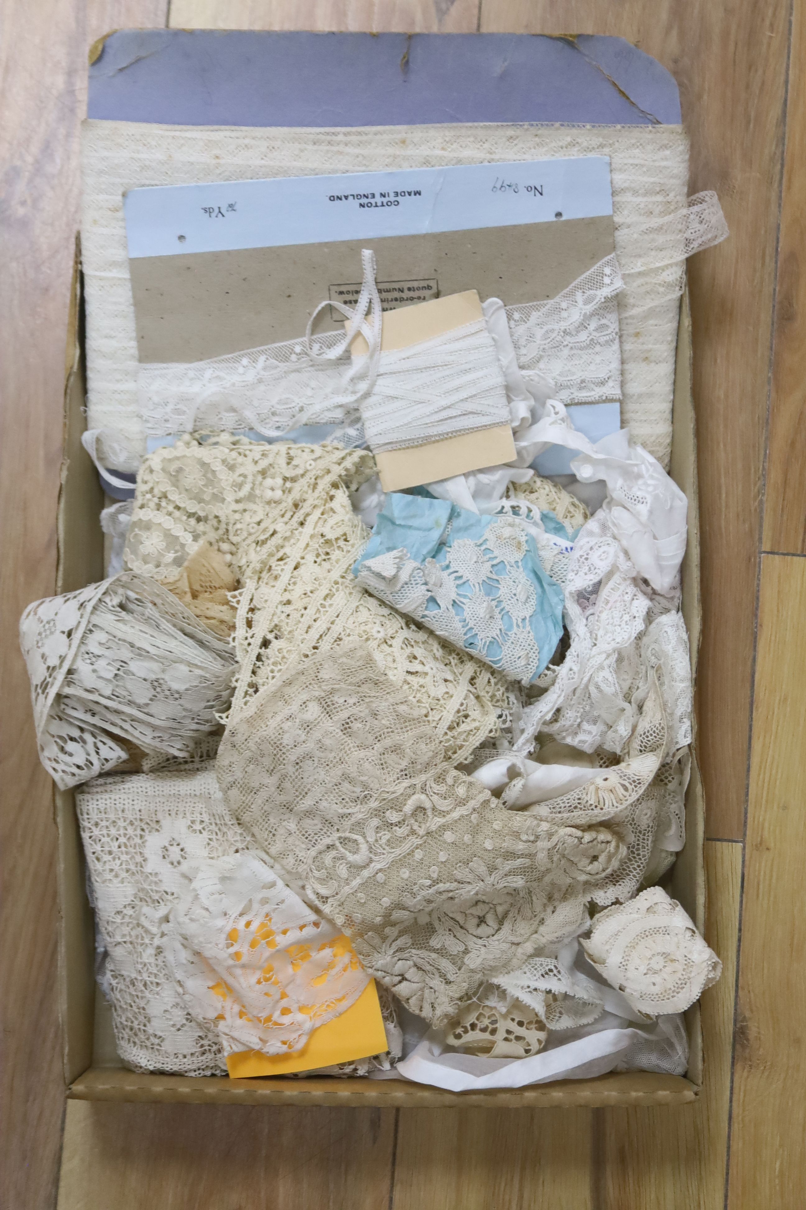 A box of mixed hand made and machine made lace trimmings